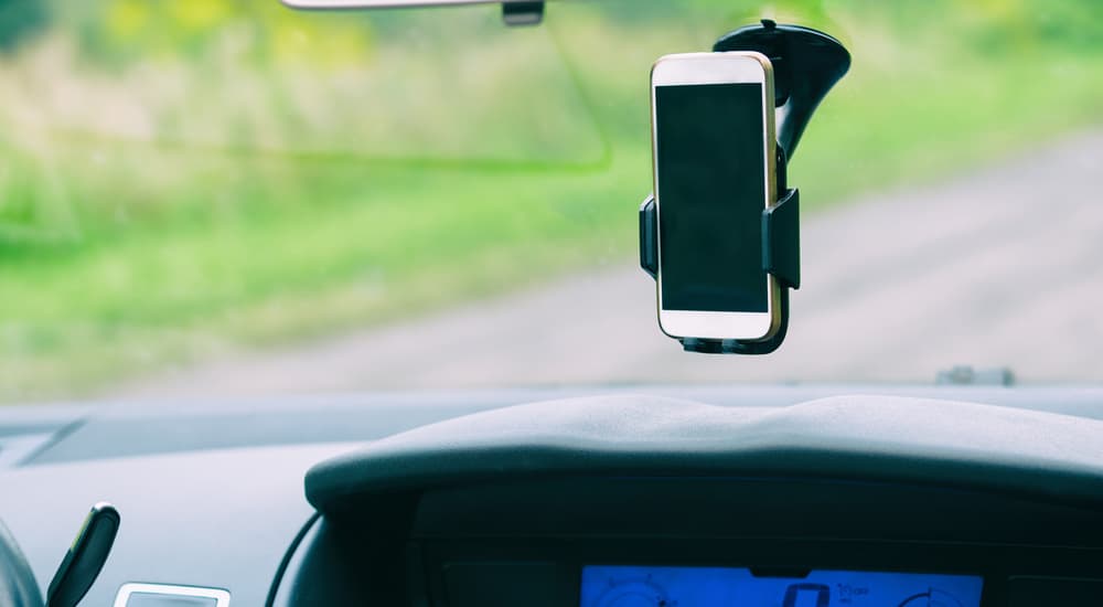A phone mount on the windshield is shown and is a popular choice in car accessories.
