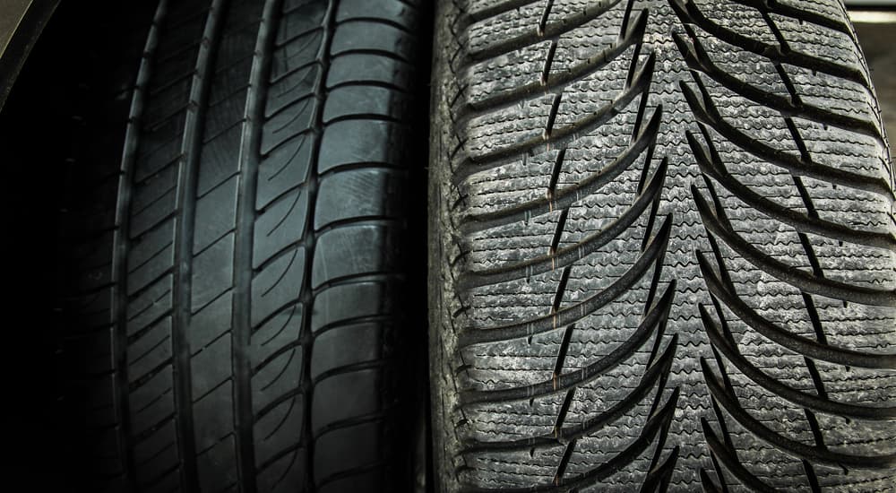 Two tires of differing tread and quality are shown next to each other.