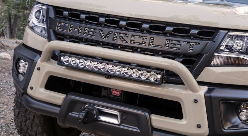The tan 2017 SEMA Chevrolet Colorado ZR2 is shown in a closeup for the truck accessories including the front bumper and light bar.