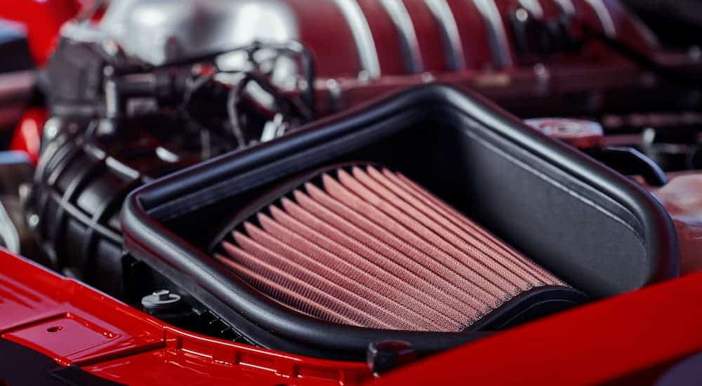 A red air intake from a 2018 Dodge Challenger is shown.