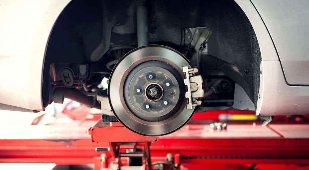 A brake set up is shown on a car with no wheel on.