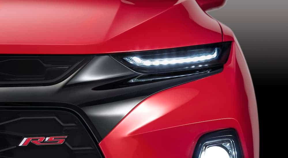 A close up of the front headlight of a Chevy SUV is shown.