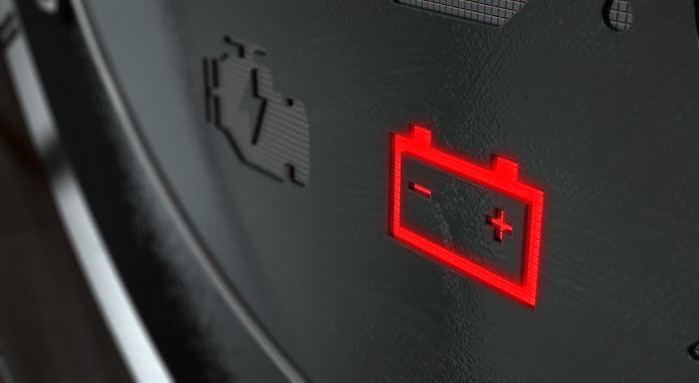 A closeup is shown of the Battery Charge Light, sometimes seen on RAM Check Engine Lights.