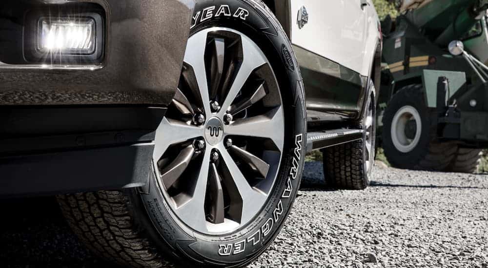 The wheel on a white 2020 Ford F-150 is shown in closeup.