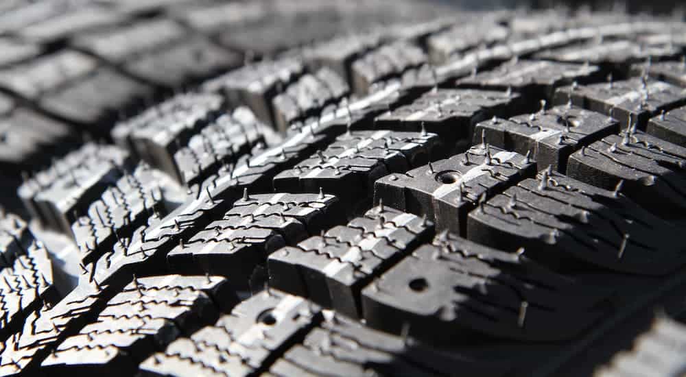 A closeup is shown of treads on a tire.