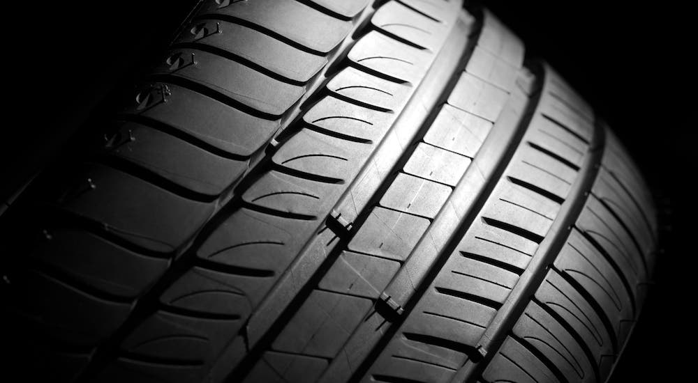 A closeup shows the texture of a car tire.