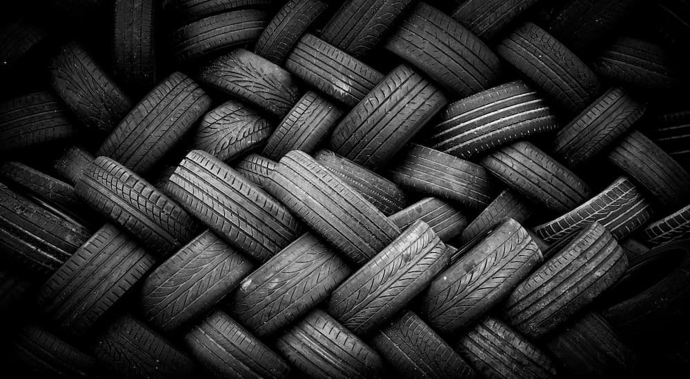 A bunch of tires are stacked up in a big pile.