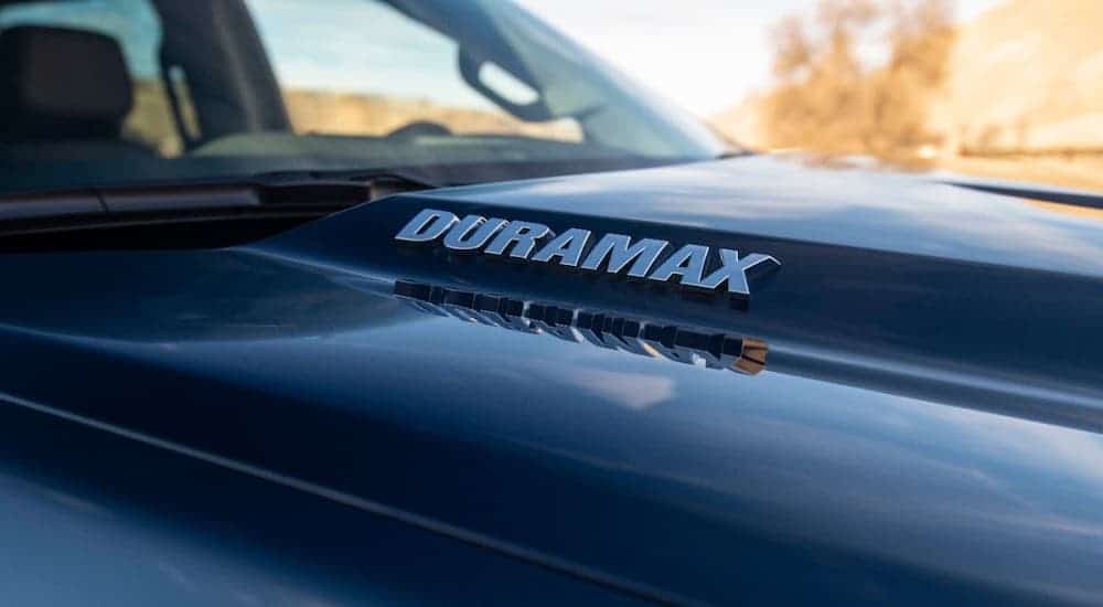 A closeup shows the Duramax badging on a black 2020 Chevy diesel truck for sale near you.