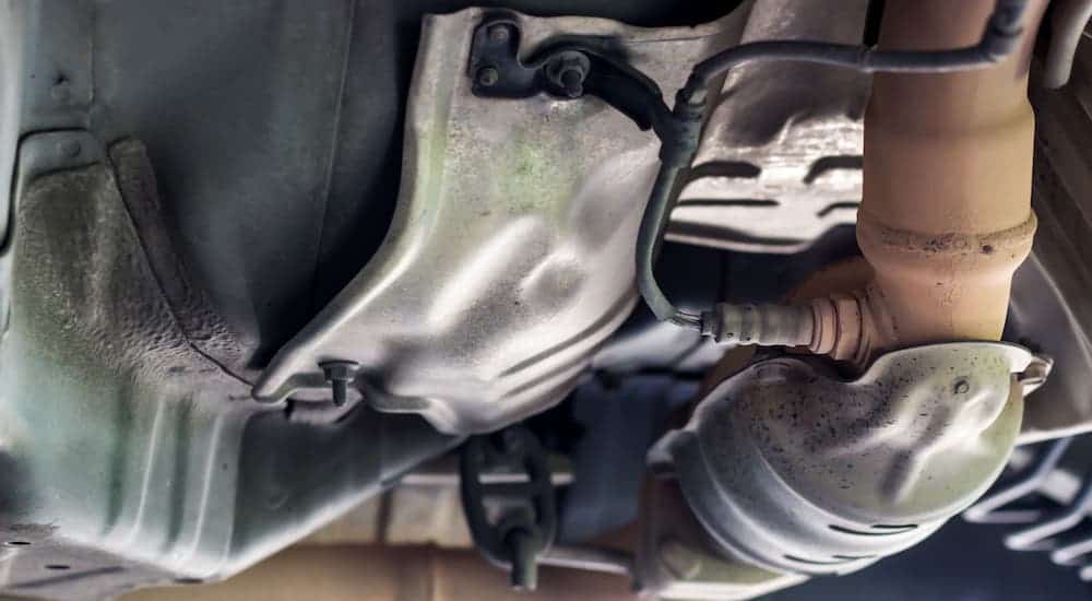 The underside of a car is shown where you can see the O2 sensor on the exhaust system.
