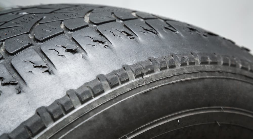 A closeup shows a worn out tire.