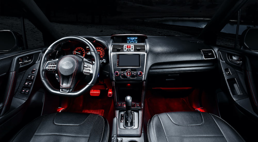 The interior of a car shows red LED custom lights.