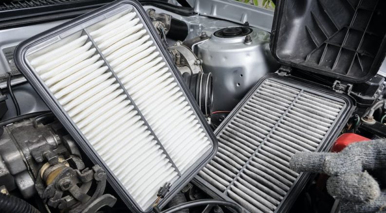A clean and dirty engine air filter are shown during an affordable auto service.