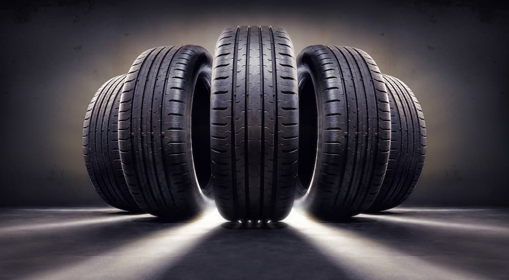 Five tires are shown illuminated by a white light.