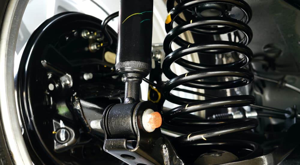 A close up of a black coil spring and shock is shown.