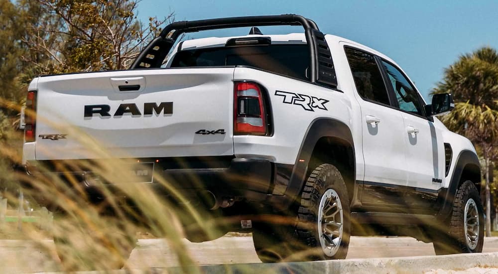 A white 2022 Ram 1500 TRX is shown from a rear angle at a Ram TRX dealer.