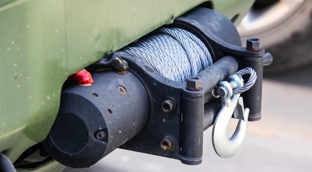 A close up shows a winch installed on a vehicle.