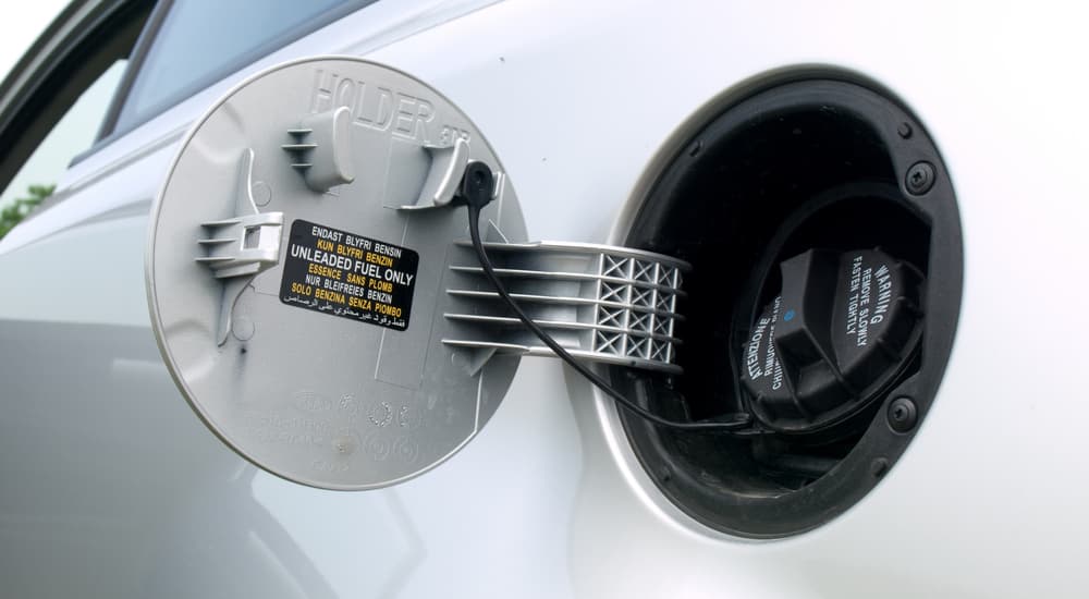 A silver vehicle's gas cap cover is shown.