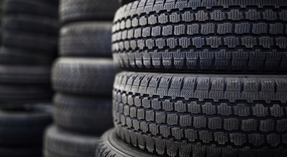 A stack of winter tires are shown in a car repair shop.