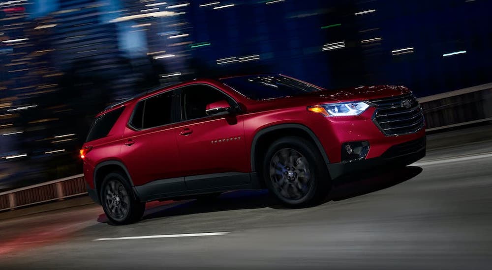A red 2021 Chevy Traverse is shown at night after visiting a Chevy Traverse dealer.
