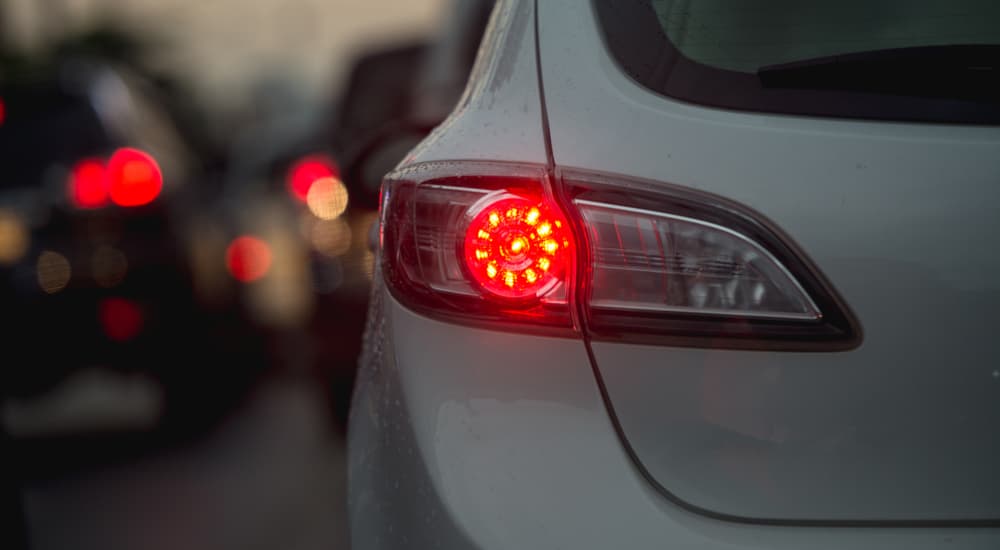 A close up of the brake light is shown on a white vehicle.