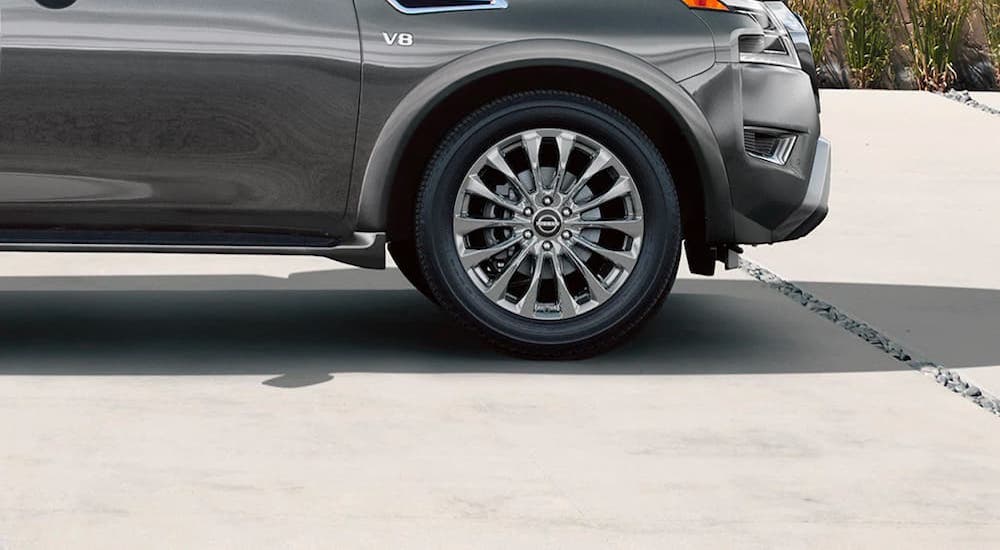 A close up shows the rim and tire on a silver 2021 Nissan Armada Platinum.