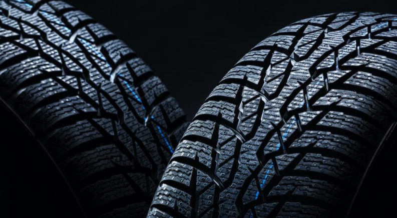 Fuel efficient tires are shown in front of a black background.