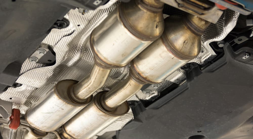 A catalytic converter is shown from underneath a vehicle.