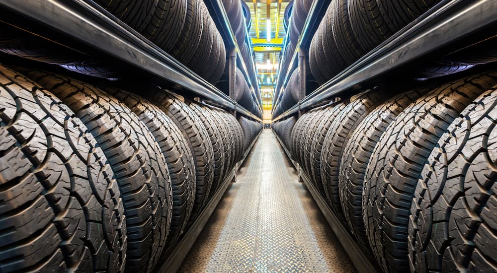 A rows of tires are shown at a tire shop.