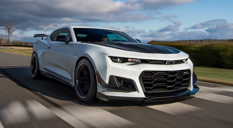 A white 2021 Chevy Camaro ZL1 is shown from the front at an angle after the owner searched 'summer tires for sale near me'.