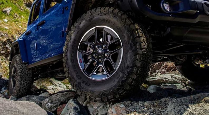 A close up of a tire on a 2019 Jeep Wrangler is shown off roading.