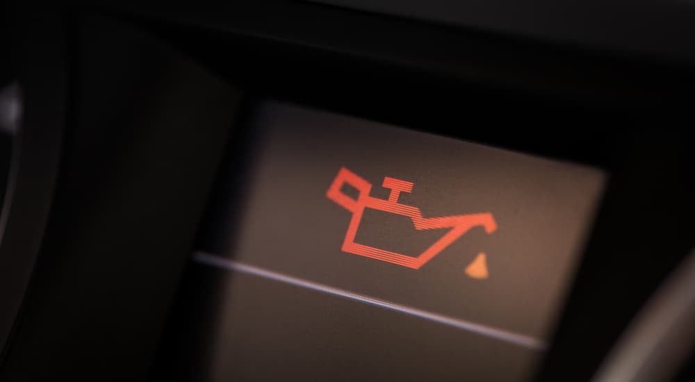 A warning oil change light is shown on the dashboard.