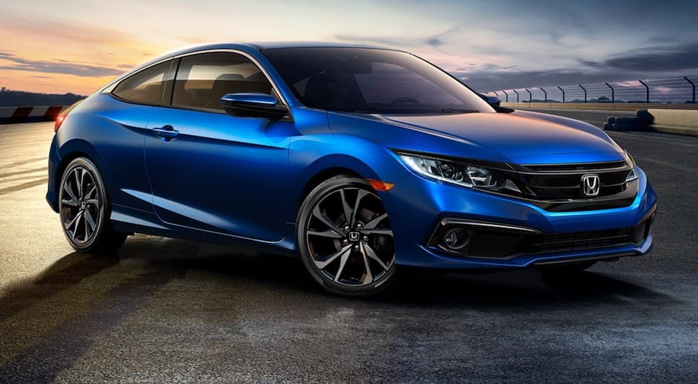 A blue 2020 Honda Civic Coupe Sport is shown from the front at an angle after leaving a shop that specializes in Honda car repair.