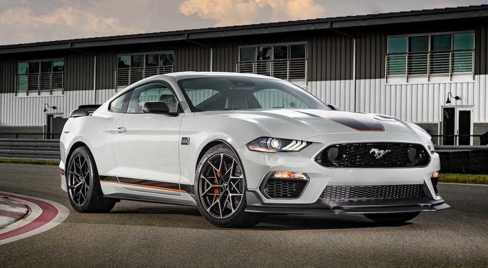 A grey 2021 Ford Mustang Mach 1 is shown from the front at an angle on a track.