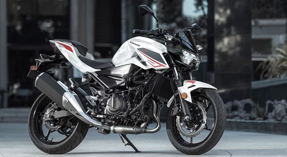 A white 2022 Kawasaki Z400 is shown from the side while parked.