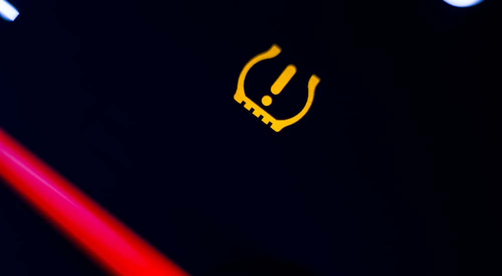 A close up of the tire pressure light on a vehicle is shown.