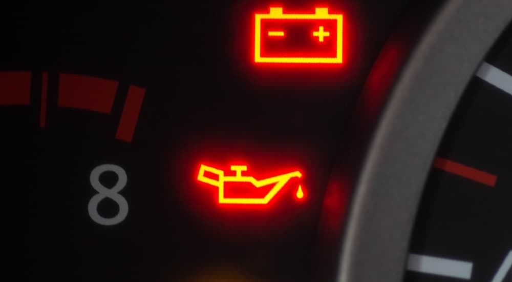 Oil and battery lights are shown illuminated on a dashboard.