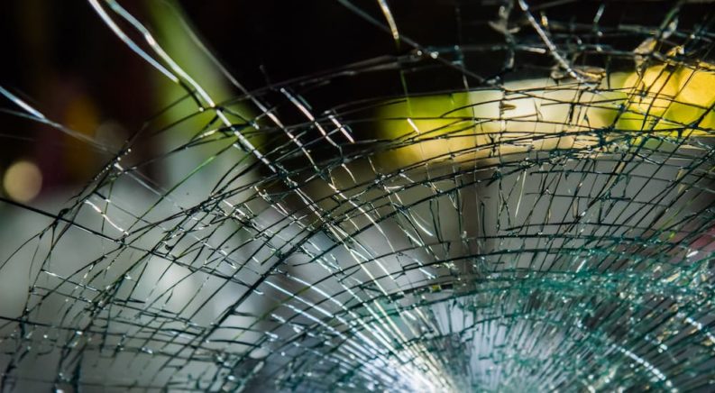 A close up shows a broken windshield.