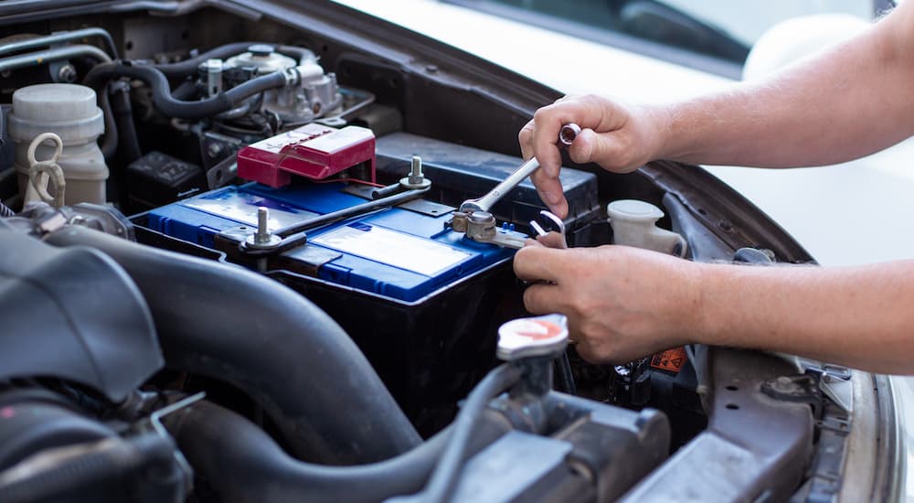A mechanic is shown changing a battery during a diesel truck service.