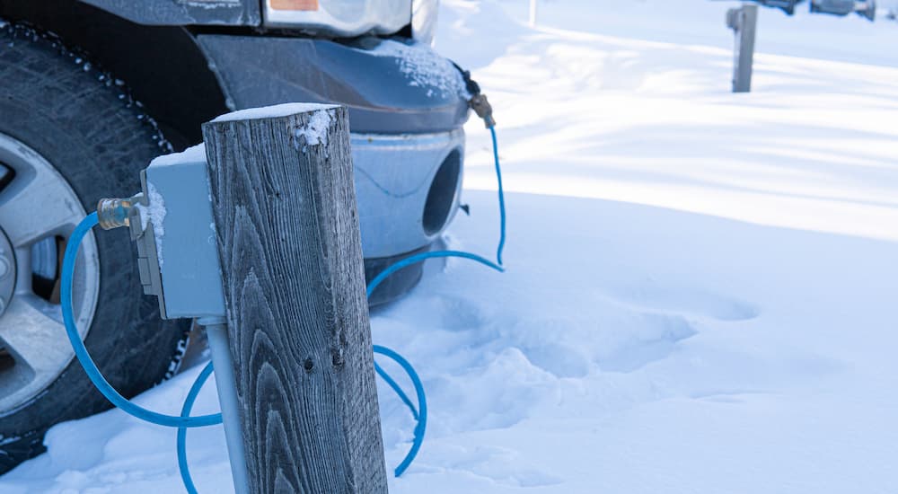 A pick up truck is shown with a block heater, parked in the snow.