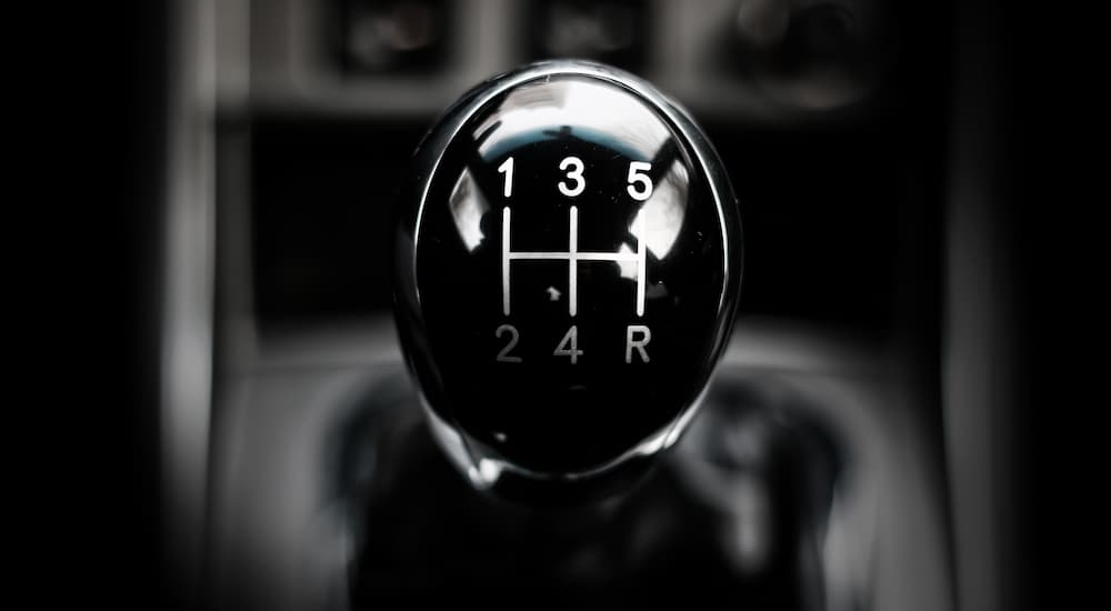 A close up of the manual shifter in a vehicle is shown.