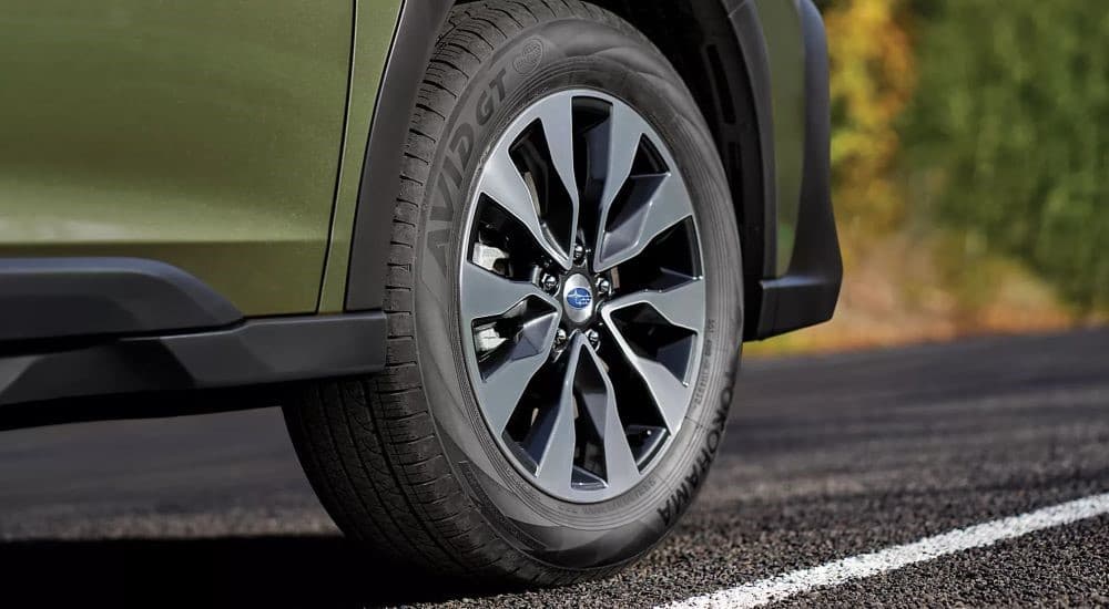 The rim and tire on a 2023 Subaru Outback for sale is shown.