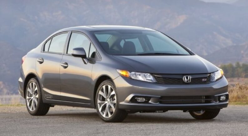 A gray 2013 Honda Civic Si is shown parked after leaving an auto repair shop.