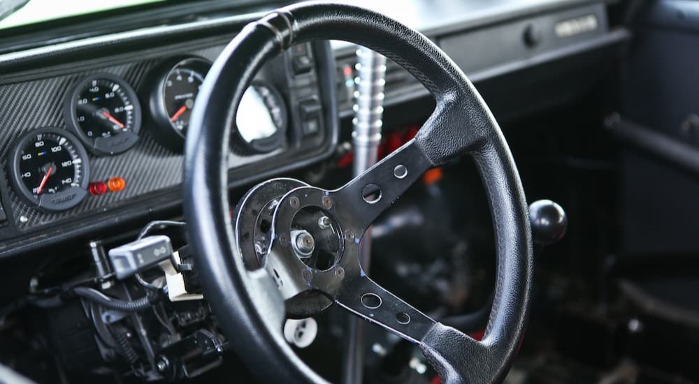 An aftermarket steering wheel is shown inside of a custom vehicle.