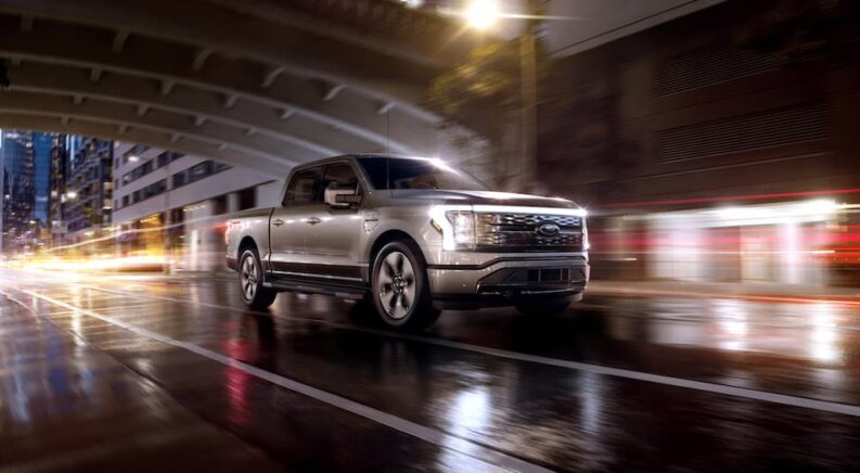 A silver 2023 Ford F-150 Lightning is shown form the front at an angle.