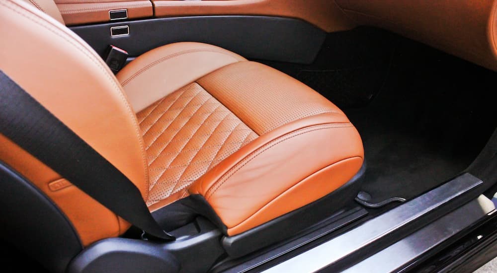 A custom orange seat cover is shown.