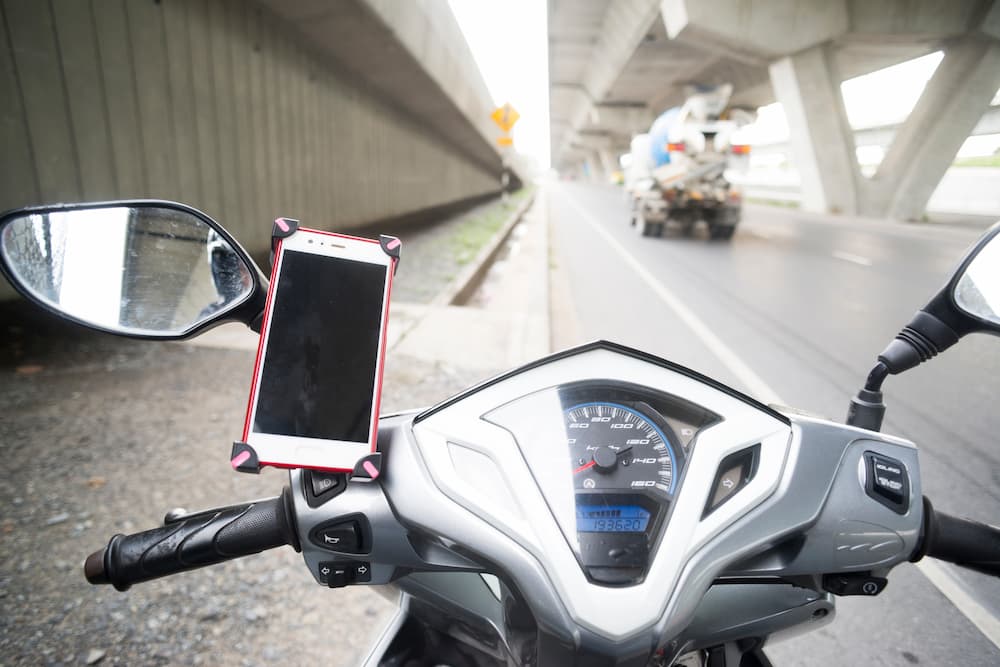 A phone mount is shown attached to a motorized scooter.