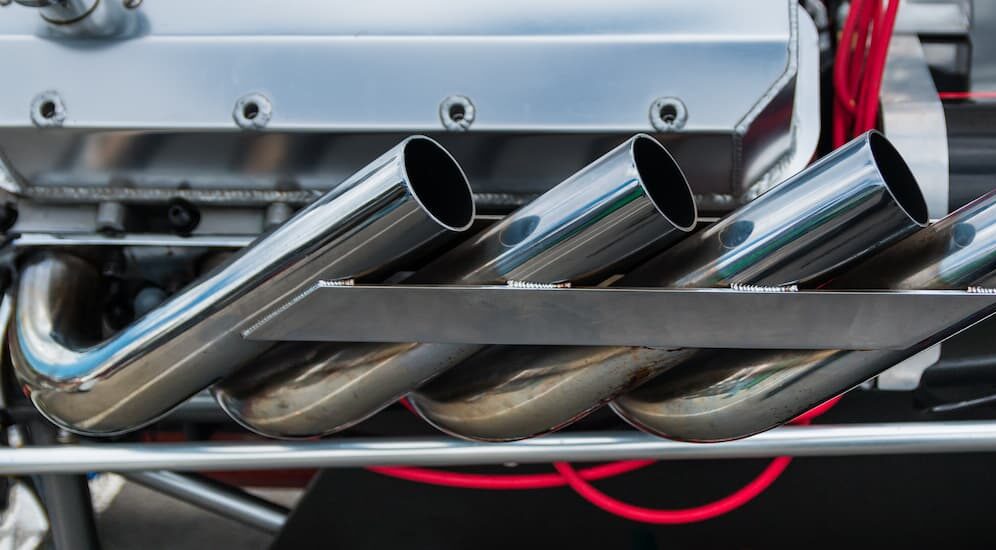 Modified exhaust pipes on a dragster are shown.
