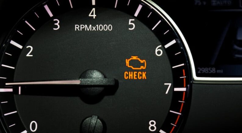 A check engine light is shown on a dash.