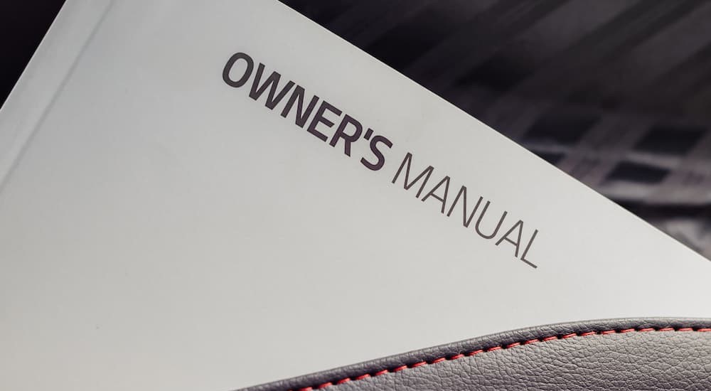A vehicles owner manual is shown.