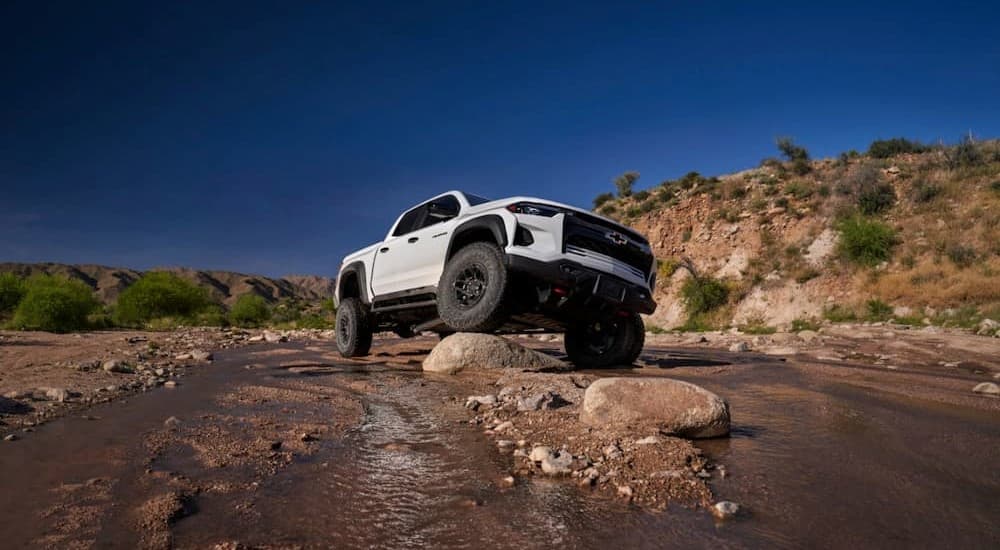 A white 2024 Chevy Colorado ZR2 Bison is shown parked off-road.